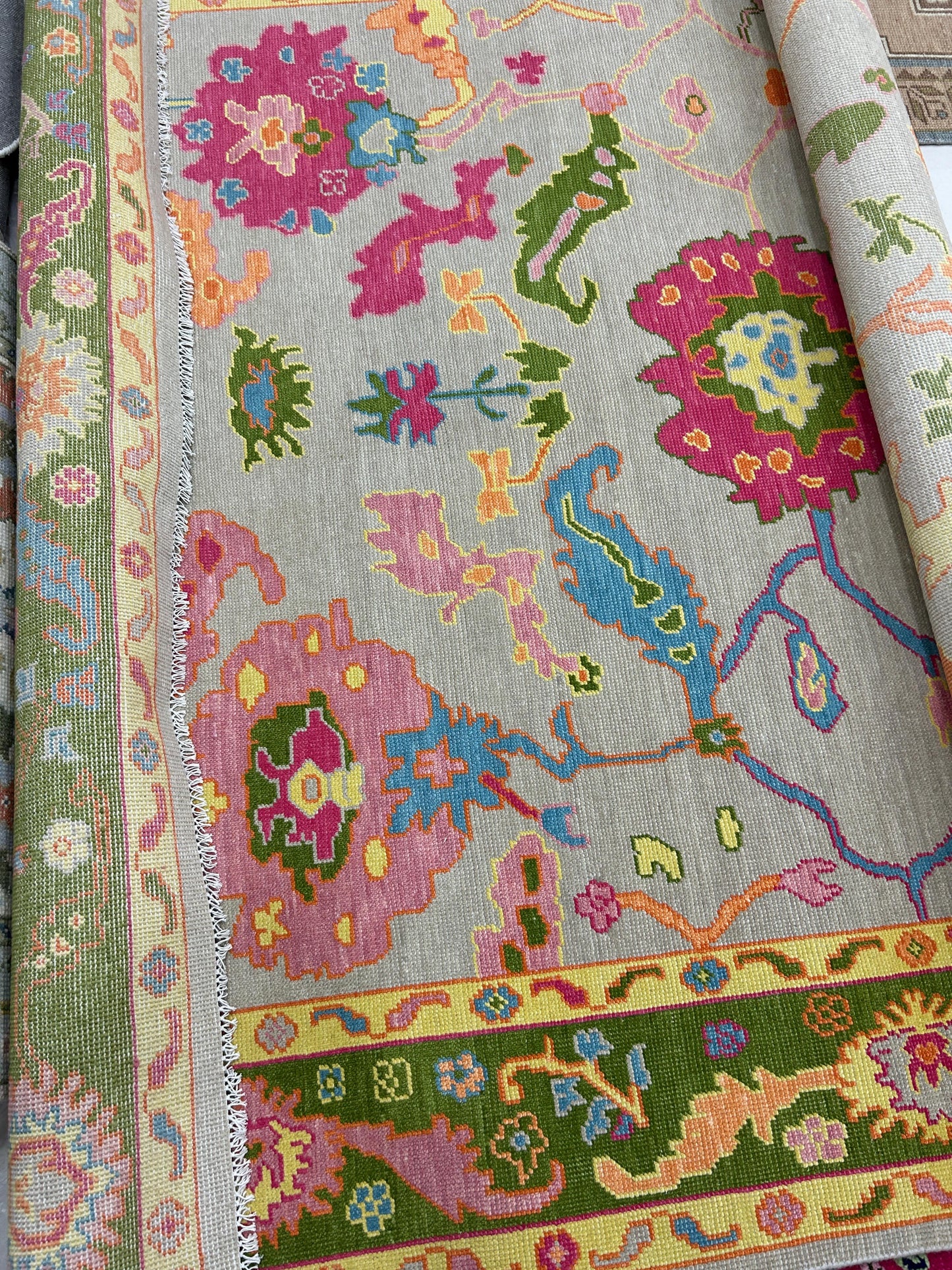 custom rug rolled out, green, pink, blue, yellow
